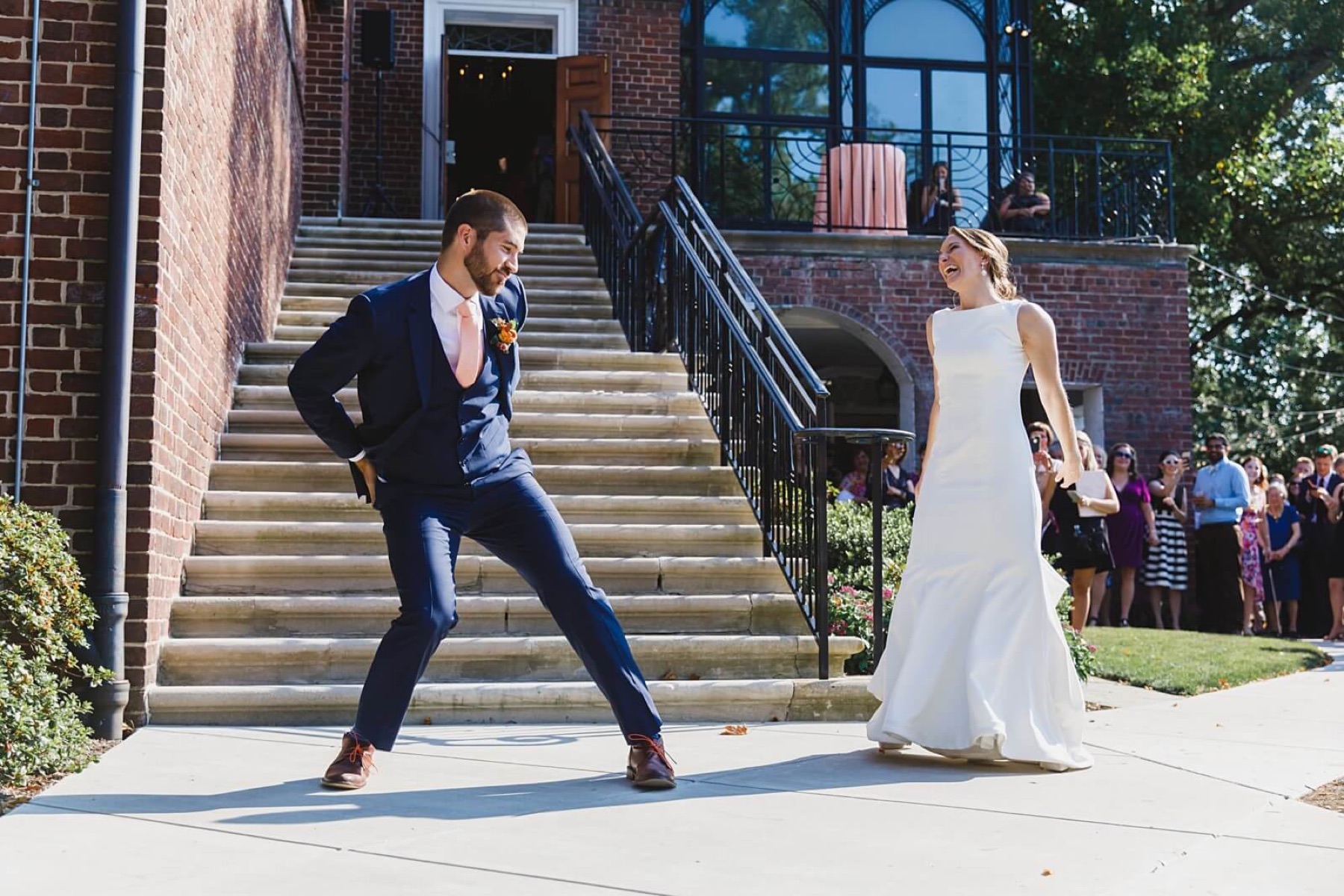 Newlyweds dancing on a terrace outside their venue